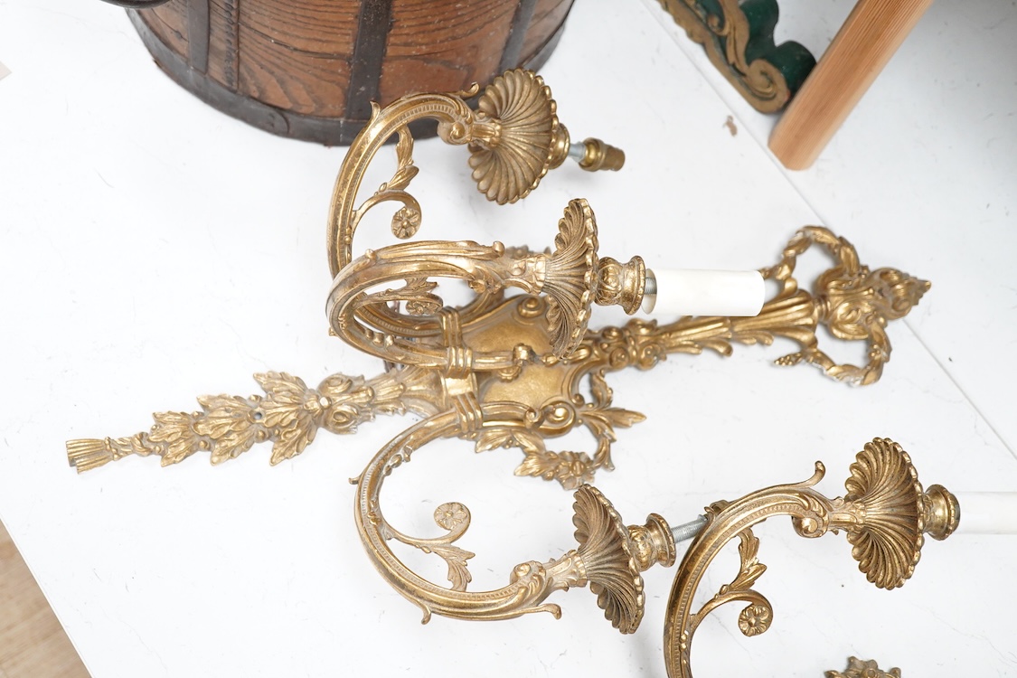 A set of four Louis XVI style three branch gilt bronze wall lights, 62.5cm high x 40cm wide